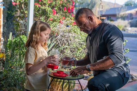 Annabelle teaches Christian Cooper how to make sugar water for the Costa Hummingbird feeders in her front yard in Palm Springs, CA. (National Geographic/Jon Kroll)