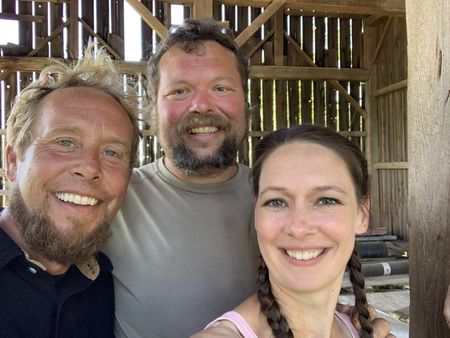 Ben Reinhold, Charles Pol, and Beth Pol smile while at the old barn they are taking down. (National Geographic)