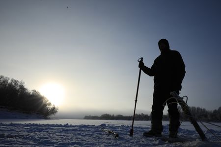 Chevie Roach sets fish nets under the ice during the winter season.  (BBC Studios Reality Productions, LLC/Brian Bitterfeld)