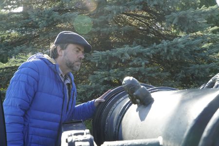 Tony Pollard inspects a replica cannon at Jasna Gora Monastery, Poland.  Jasna Gora Monastery, Poland. In 1655 the monastery defended itself against an onslaught from the Swedish army.  (National Geographic/Ciaran Henry)