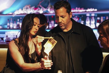 David Blaine burns a 10,000 yen note during his bill restore trick. (credit: National Geographic/Dana Hayes)