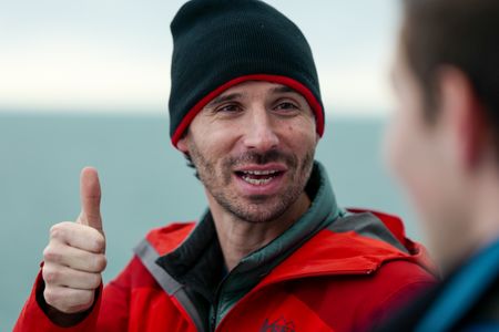 Eric Stackpole giving a thumbs up aboard the OceanXplorer. (National Geographic/Mario Tadinac)