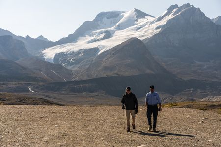 Joseph and Ranulph Fiennes walk near the Athabasca Glacier.  Sir Ranulph Fiennes, "the greatest living explorer," and his cousin, actor Joseph Fiennes, revisit Ran’s 1971 expedition of Canada’s British Columbia.