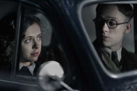 A SMALL LIGHT - Miep and Jan Gies, played by Bel Powley and Joe Cole, wait in a car as seen in A SMALL LIGHT. (Credit: National Geographic for Disney/Dusan Martincek)