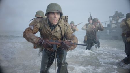 Corporal William Dabney (played by Joshua Riley) arrives on Omaha beach in a scene of a WW2 historic reenactment production for "Erased: WW2's Heroes of Color."  Corporal Dabney served with the 320th Barrage Balloon Battalion on D-Day. (National Geographic)