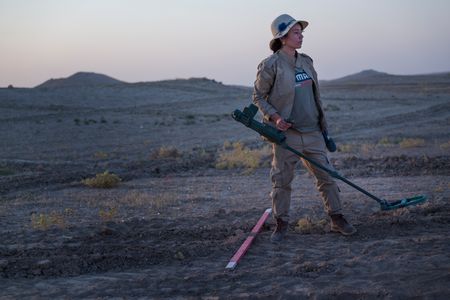 Sinjar, Iraq - Hana searches for mines in a field at dawn. (Sean Sutton)