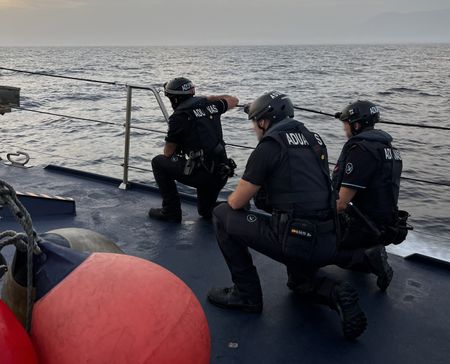 Agents of the customs surveillance service prepared for a boarding. (National Geographic/Livan García Nogueira)