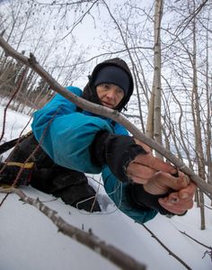 Denise Becker sets rabbit snares for food. (BBC Studios Reality Productions/Ben Mullin)