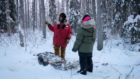 Ricko DeWilde and his daughter, Skarlett stumble upon a carcass in the wilderness. (BBC Studios/Ryan Walsh)