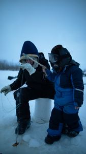 Tinmiaq Hailstone teaches her son Sabastian how to ice fish during the winter. (BBC Studios Reality Productions, LLC/Pedro Delbrey)