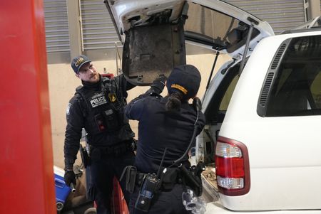 CBP Officers Hernandez and Hoffman work to dismantle the trunk of a suspect's vehicle in search of smuggled drugs in Calexico, Calif. (National Geographic)