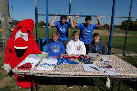 Encouraging folks to donate blood, Chase Schroeder wears the blood drop mascot as Charlie Schroeder poses with Cal Watanabe, Carson and Colin Wieseler, and Dylan Heine at a 5K fundraiser. (National Geographic)