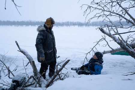 Chevie Roach teaches his son Ryder how to set marten traps along their trapline. (BBC Studios Reality Productions, LLC/Jayce Kolinski)