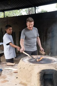 Oaxaca, Mexico - Jorge (L) teaches Gordon Ramsay how to make mole using a family recipe. This step involves lighting chili pod seeds on fire. (Credit: National Geographic/Justin Mandel)