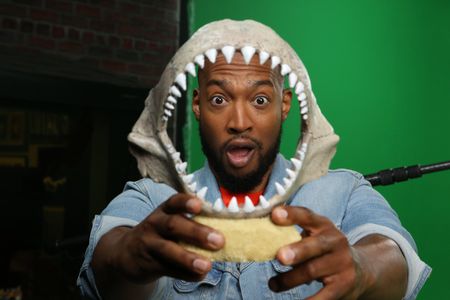Keon Poole's face inside of a display shark jaw. (National Geographic/Robert Toth)