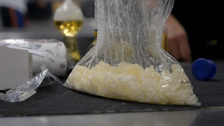 CBP is concerned by the appearance of multiple bags of starch that were placed on an inspection table after they were found in a passenger's luggage in Atlanta, Ga. (National Geographic)