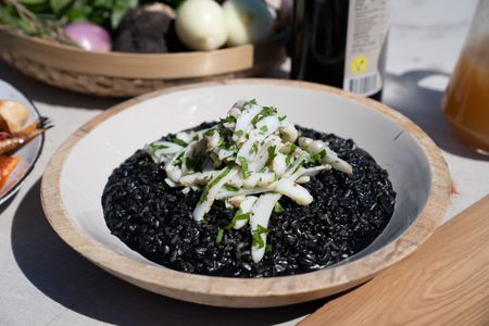 Croatia - Black Risotto finished with a marinated cuttlefish salad. (Credit: National Geographic/Justin Mandel)