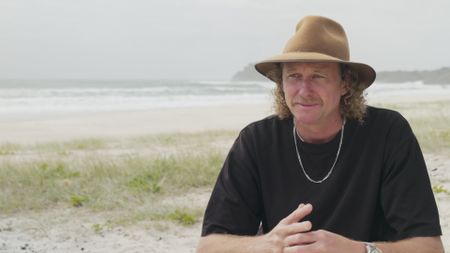 Christian Bungate, contributor, reflecting on his encounter with a shark attack while out surfing on his hydrofoil in the ocean. (National Geographic)