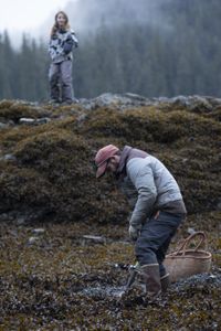 Cole Sturgis collects clams with his daughter, Timber along the shoreline. (BBC Studios Reality Productions, LLC/Lukas Taylor)