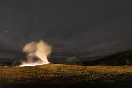 Old Faithful erupting at night. (National Geographic/Jake Hewitt)