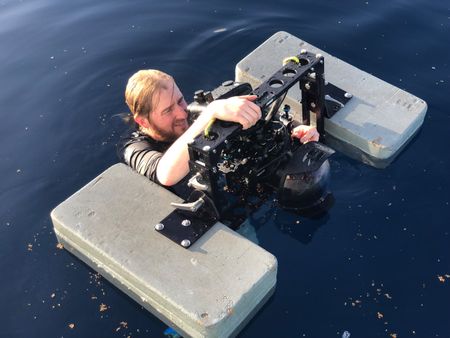 Camera Operator Jimmy Cape in the waters off Maui, HI with an underwater rig. (National Geographic for Disney/Ruth Davies)