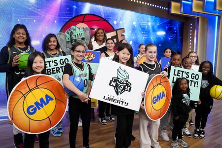 MASCOT ELLIE, ROBIN ROBERTS, BASKETBALL GROUP IN JERSEYS