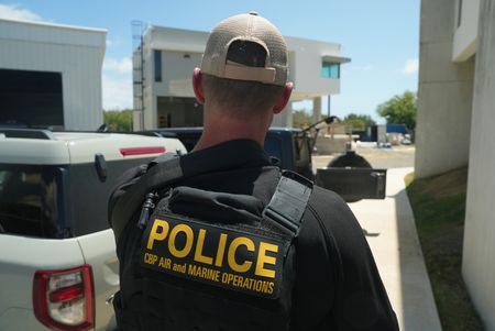 A CBP AMO agent is gearing up and preparing to head out for an operation in Fajardo, P.R. (Lucky 8 TV/Paul Taggart)