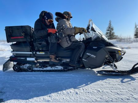 Director of photography Simon Niblett films from a Skidoo. (National Geographic for Disney/Duncan Chard)