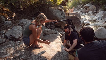 Angel Collinson helps cinematographer Nick Kraus and assistant cameraperson Galen Murray make their way up a creak.   (National Geographic/Elena Gaby)