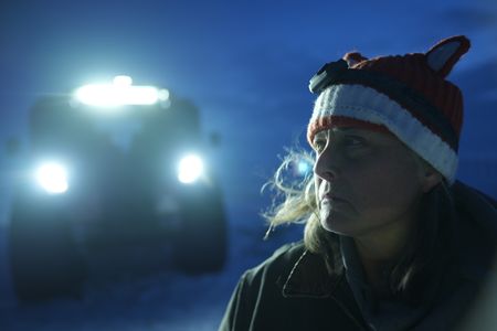 Sue Aikens stops to gather fresh water while traveling towards the Arctic Ocean in the dark. (BBC Studios Reality Productions, LLC/Jayce Kolinski)