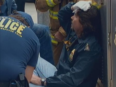 Luke Franey, who has just escaped through the rubble, is lead away from the scene at the Alfred P. Murrah Federal Building in Oklahoma City, Okla., April 19, 1995.  (News9 Oklahoma City)