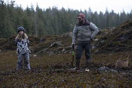 Cole Sturgis collects clams with his daughter, Timber along the shoreline. (BBC Studios Reality Productions, LLC/Lukas Taylor)