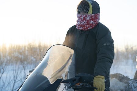Tig Strassburg heads out on his snowmobile to set wolf and wolverine traps. (National Geographic/Pat Henderson)