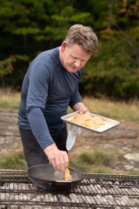 Michigan - Gordon Ramsay cooks fresh lake trout during the final cook in Michigan. (Credit: National Geographic/Justin Mandel)