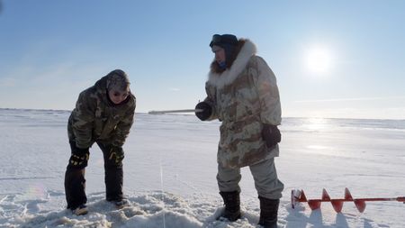 John 'Sonna Boy' Pingayak III and John Pingayak ice fishing in the tundra. (National Geographic)