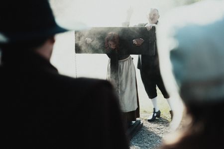 An accused witch is locked in a pillory by a judge. (Dash Productions Services LTD/Antoan Ivanov)