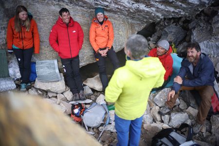 The team shelter under a rock at the Pool wall base camp. (photo credit: National Geographic/JJ Kelley)