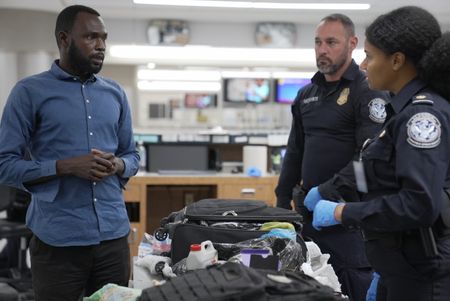 CBP Officers Evans and Mccants question a passenger while going through their belongings in Atlanta, Ga. (National Geographic)