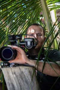 Camera assistant, Woody Spark, filming topside on Bunaken Island.  (photo credit: National Geographic/Annabel Robinson)