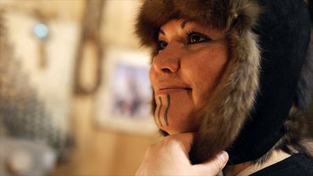 Jody Potts-Joseph tries on a hat she made out of trapped marten fur. (National Geographic)