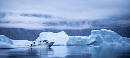 Boat travelling through icebergs. (photo credit: National Geographic/Pablo Durana)