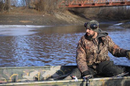 Chevie Roach maneuvering his boat on the Innoko River before  heading out to hunt beaver with his daughter, Sydney Roach. (BBC Studios Reality Productions, LLC/Brian Bitterfeld)