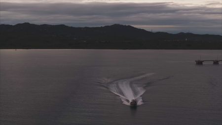 A CBP AMO boat is pictured out on the open waters with the island in the background near Mayaguez, P.R. (Lucky 8 TV/Paul Taggart)