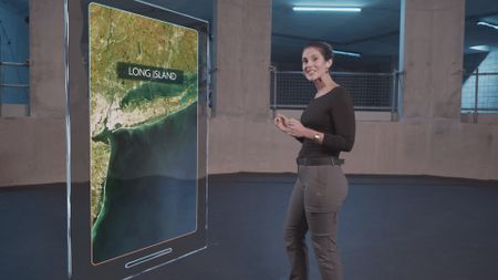 Dr. Diva Amon speaking to camera next to a GFX map of Long Island whilst in the shark lab studio. (National Geographic)