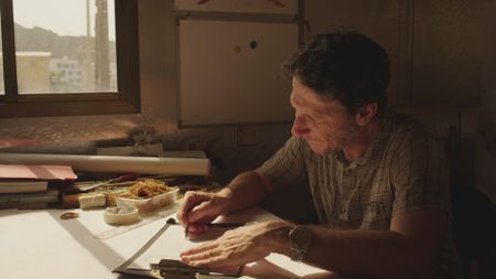 Maritime archaeologist Alessandro Ghidoni draws up designs for typical ancient reed boats. (Windfall Films)