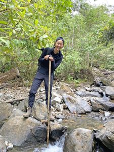 Chef Kristen Kish poses while crossing a stream in Panama's Chiriqui province. (National Geographic for Disney/Missy Bania)