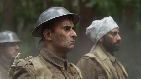 Captain Anis Khan (played by Shammi Aulakh) and Medic Siddiq Ahmed (played by Rishi Rian) walk through the forest with other members of his unit after they were taken prisoners by the Germans in a WW2 historic reenactment scene for "Erased: WW2's Heroes of Color." (National Geographic)