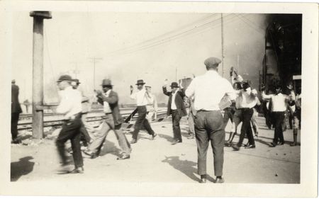 Detainees being marched along the train tracks with their arms raised, during the Tulsa Race Massacre of 1921. (University of Tulsa, McFarlin Library)