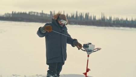 Gilbert drills holes in ice to catch some fish. (Blue Ant Media/Tara Elwood)