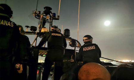 Agents of the customs surveillance service sail at night. (National Geographic/Antonio Javier López Castillo)